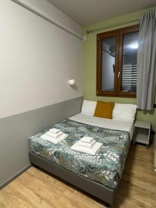 Postel nebo postele na pokoji v ubytování Hotel Camilla Guelfa
