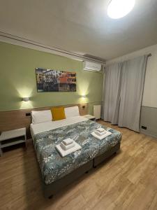 Postel nebo postele na pokoji v ubytování Hotel Camilla Guelfa