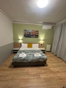 Postel nebo postele na pokoji v ubytování Hotel Camilla Guelfa