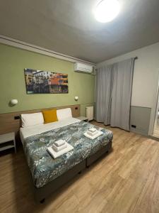 Postel nebo postele na pokoji v ubytování Hotel Camilla Guelfa
