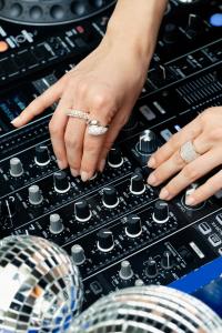 a woman with her hands on top of a mixing console at Chouchou Hotel in Paris