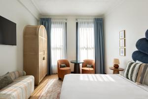 a hotel room with a bed and a couch at Granger Hotel San Diego Downtown Gaslamp Quarter, a Member of Design Hotels in San Diego +72 photos