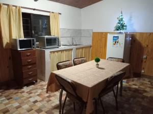 a kitchen with a table with chairs and a christmas tree at Chacra Don Joaquin 2 in La Cruz