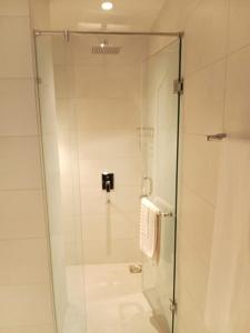 a shower with a glass door in a bathroom at TAJ Hotel in Islamabad