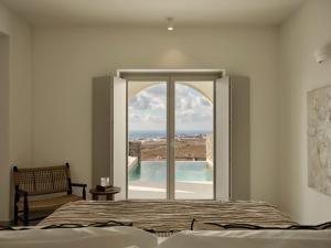 a bedroom with a bed and a window with a view at Ark in Pirgos