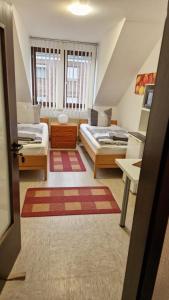a attic room with two beds and a room with a bed sqor at Zimmer C in Mönchengladbach