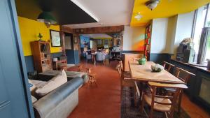 a living room with a couch and a table at au petit quinquin in Céaux
