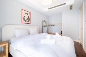 a white bedroom with a large white bed at Luxury Apartments in Ofton Residence in Istanbul