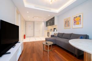 a living room with a gray couch and a table at Luxury Apartments in Ofton Residence in Istanbul