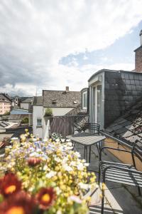 a balcony with a table and chairs and flowers at Sam & Karo Boutique Apartment in Trier