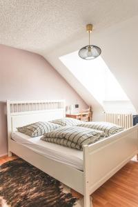 a bedroom with a white bed in a attic at Sam & Karo Boutique Apartment in Trier