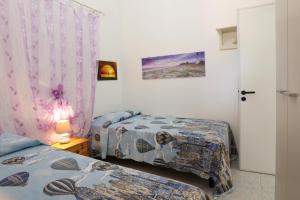 Postel nebo postele na pokoji v ubytování A due passi dal mare by Salento Prime