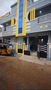 a building with a motorcycle parked in front of it at Subramanya Inn in Tiruchchendūr
