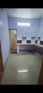 a empty room with a table and a hallway at Subramanya Inn in Tiruchchendūr