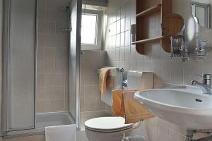 a bathroom with a sink and a toilet and a shower at Auf der Heide Gasthof & Pension in Waltersdorf +11 photos