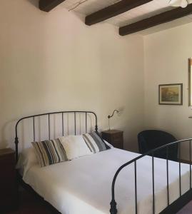 a bedroom with a bed and a chair at Tenuta Cerreto in Torre Orsaia +33 photos