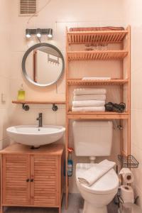 a bathroom with a sink and a toilet and a mirror at Sam and Karo City Studio in Trier