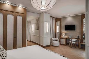 a bedroom with a bed and a desk in a room at Vincci Soho in Madrid