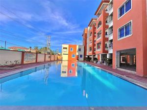 a pool of blue water in a street with buildings at SUMMERDAY PALACE in Mtwapa