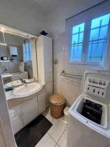 a small white bathroom with a sink and a sink at Gite - La Boutardière in Rilly-sur-Loire