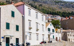 a group of buildings with motorcycles parked in front of them at Fora Apartments in Dubrovnik