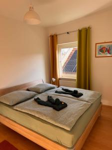 a bedroom with a bed with two slippers on it at ApartmentRegina, renoviert! in Knittelfeld