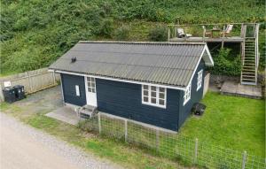 a small blue house on the side of a road at Awesome Home In Mariager With Wifi in Mariager