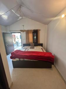 a bedroom with a bed with a red blanket at Shivalik HomeStay & BayleafCafe in Nainital +17 photos