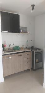 a kitchen with a sink and a stove at Studio 6677 Aptº302 Em frente ao Projac da Globo in Rio de Janeiro +13 photos