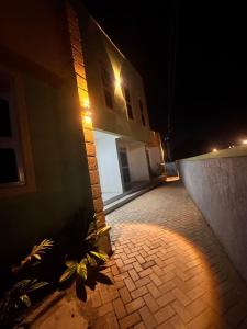 a building with a light on the side of it at night at Fatisa private homes in Kampala