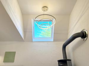 a light hanging from a ceiling with a window at grün in grün in Detmold