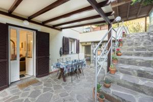 a patio with a table and chairs on it at Casa Anna a Pomonte - Goelba in Pomonte