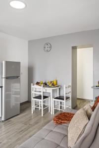 a kitchen and dining room with a table and a refrigerator at Seaside Charm II in Câmara de Lobos +14 photos