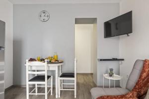 a small living room with a table and a chair at Seaside Charm II in Câmara de Lobos