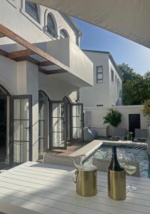 a home with a swimming pool and a house at 2 Riverside Oaks in Franschhoek