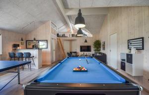 a pool table in the middle of a room at 8 Bedroom Beautiful Home In Grenaa in Grenå
