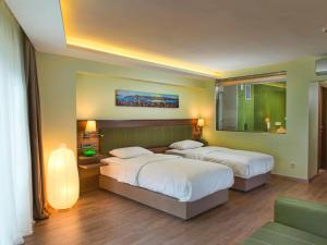 Postel nebo postele na pokoji v ubytování Numi Hotel