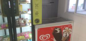 a cooler in a store with a sign on it at Studio 6677 Aptº302 Em frente ao Projac da Globo in Rio de Janeiro