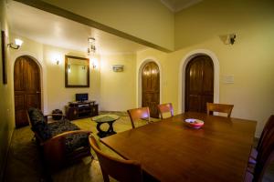 a dining room with a wooden table and chairs at Pinnacle Holiday Homes in Arpora +35 photos