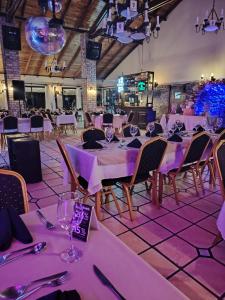 a dining room with purple tables and chairs at El Descubrimiento Resort Club in Guazuvira +142 photos