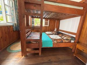 a bedroom with a bunk bed in a cabin at Chambre gite d'étape les Carillons in Cilaos