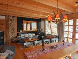 a living room with a couch and a table at La Cassa Chalet Adults only in Vişeu de Sus