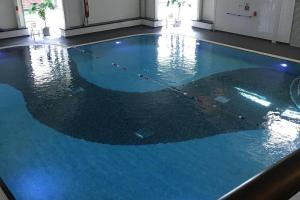 a large pool with blue water in a building at Lakeland Lodge- 3Bed-2 Bath- Private Patio in Carnforth