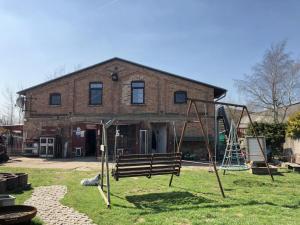 a playground in front of a brick house at Ferien auf dem Bauernhof Nr. 101 in Altenhagen