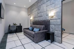 a living room with a couch and a table at Cesare ai Cavalieri Suites in Rome