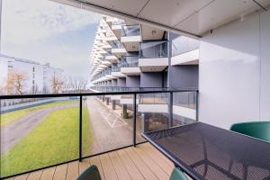 a balcony with a view of a building at Horyzont Apartamenty- Seaside Apartament prywatny z widokiem na morze in Kołobrzeg