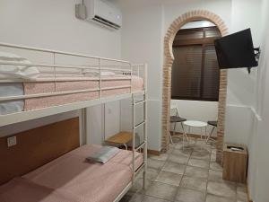 Ένα ή περισσότερα κρεβάτια σε δωμάτιο στο Coliving Noviciado