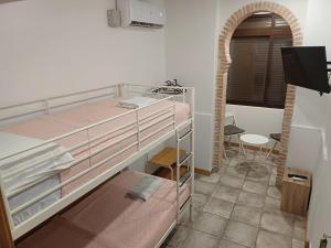 Ένα ή περισσότερα κρεβάτια σε δωμάτιο στο Coliving Noviciado