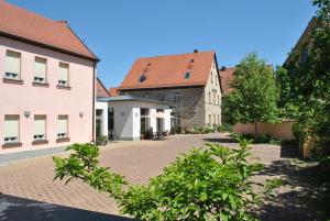 a cobblestone street in a town with buildings at Hotel Centro in Schwabach