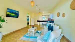 a living room with a couch and a table at Bamburi Beach Villa in Mombasa